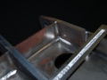Steel-airport-cart-tow-bracket-robotic-arc-welding-Automated-fabrication-high-volume-production-GMAW-custom-fabrication-Kzell-Metals-Phoenix-Arizona